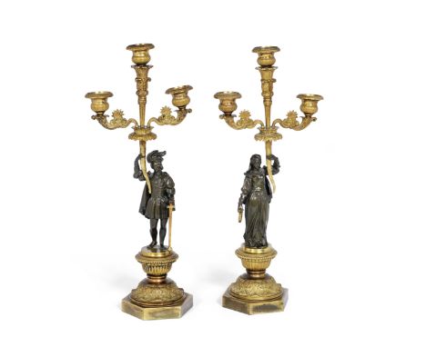 A pair of Louis Philippe gilt bronze figural candlebrain the Troubadour stylethe scrolling foliate arms with reeded urn nozzl