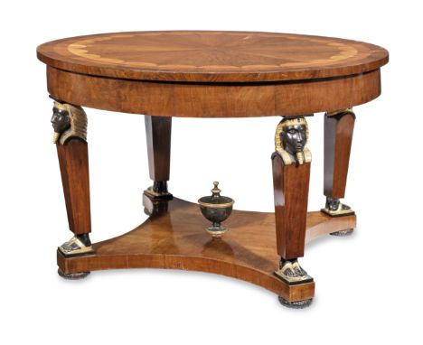 An Italian 19th century walnut, satinwood, ebonised and parcel gilt centre tablein the Egyptomania tasteThe circular radiatin