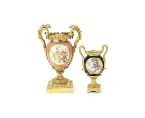 Two late 19th century French gilt bronze mounted Sevres style porcelain urnsthe larger with a pink ground, the other with a b