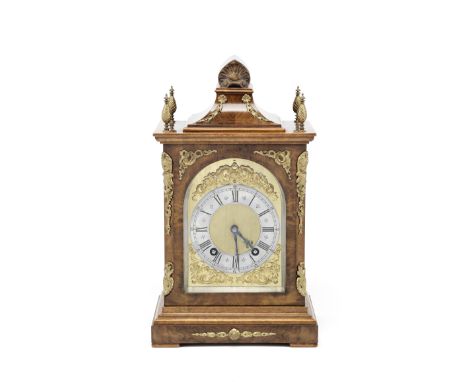 An early 20th century gilt brass mounted walnut mantel clockthe movement stamped Lenzkirch the swept top with shell carved pe