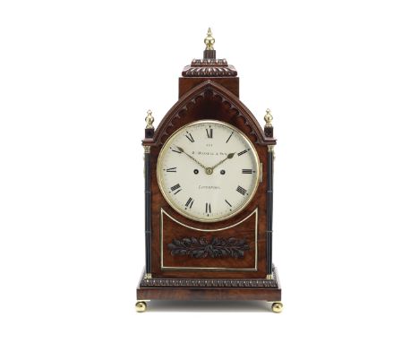 A William IV carved mahogany bracket clockRobert Roskell and Sons, Liverpool  No.881The lancet case with three brass finials 