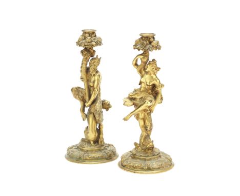 A pair of French 19th century gilt bronze figural candlesticksOne modelled as Pan seated on top of a leopard and holding alof