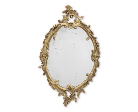 A 19th century Rococo revival giltwood mirrorThe later plate within a C-scroll, rocaille, scrolled foliate and floral carved 