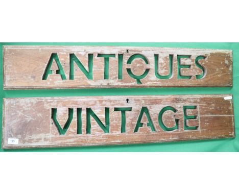 2 wooden signs one saying Antiques and the other Vintage 