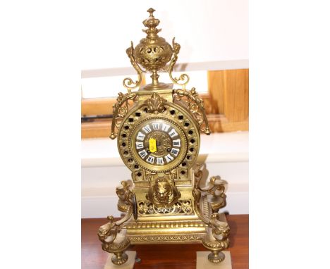 An early 20th century French gilt spelter mantel clock, enamel Roman numerals, twin winding holes and urn finial, on turned s