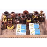 Sixteen miniature slip decorated vases and four Wade Whimsies, boxed