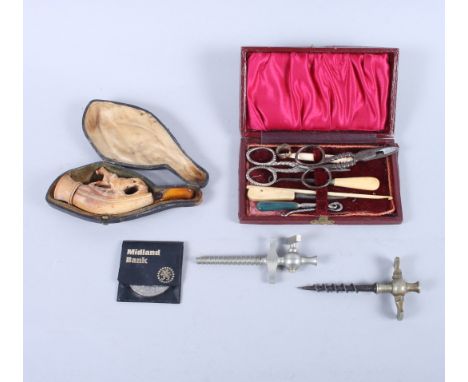 A meerschaum pipe decorated horse and hound in fitted case, two champagne taps, a leather cased sewing set and a commemorativ