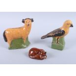 An early 19th century pottery money box, formed as a ram, 6" high, a 19th century pottery money box,