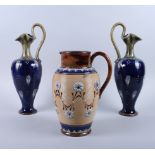 A pair of Royal Doulton stoneware Art Nouveau floral relief decorated jugs 12" high, a Doulton