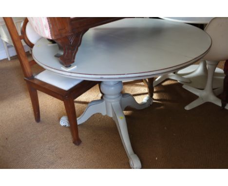 A painted and distressed mahogany circular tilt top dining table, on tripod splay support, 48" dia