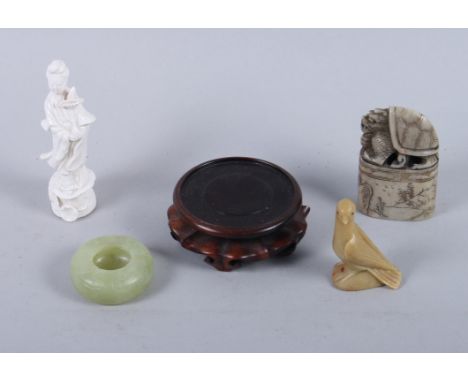 A 19th century Chinese jade brush washer with incised decoration, a small Chinese blanc de chine model of Guanyin, a Chinese 