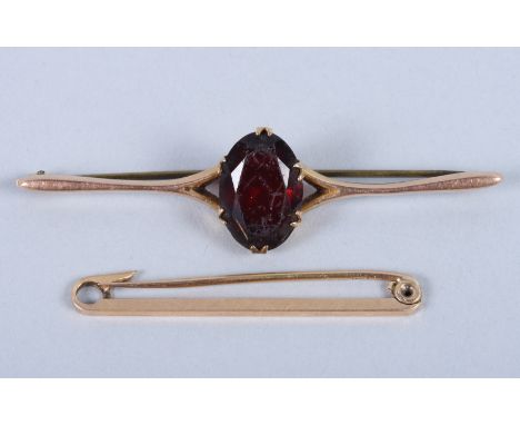 A 15ct gold tie pin and a 9ct gold and red stone brooch