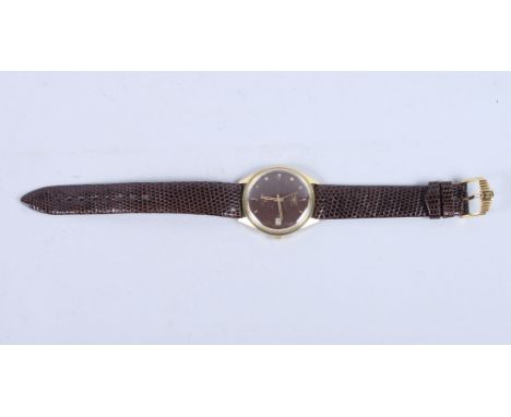 A Longines Ultra-Chron automatic wristwatch with crimson enamel dial, baton numerals and date aperture at three o'clock