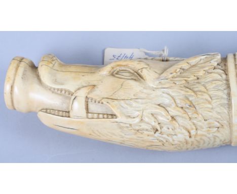 A 17th century carved ivory ceremonial hunting horn with wild boar head mouth piece and hunting scene