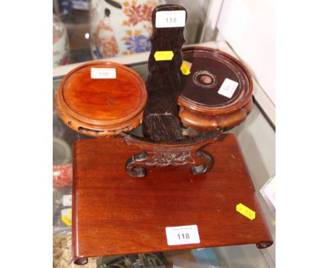 A Chinese carved hardwood scroll-shaped stand and three other hardwood stands