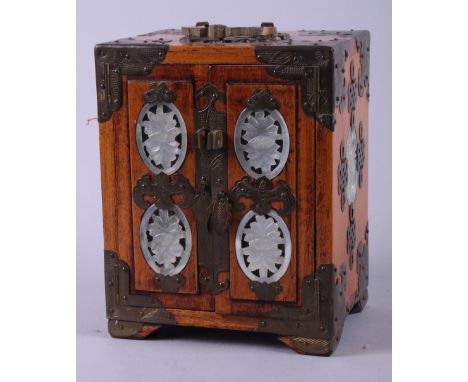 A miniature Chinese hardwood cabinet with brass mounts and green hardstone roundels, three drawers enclosed two doors, 7" hig