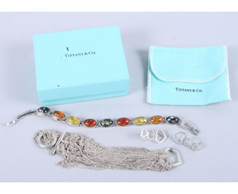 A silver Tiffany & Co heart-shaped locket with white trademark chain, a boxed pair of Tiffany style earrings and a white meta