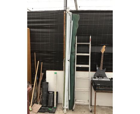 A LARGE WIND OUT AWNING AND A TWELVE RUNG TWO SECTION ALUMINIUM LADDER 