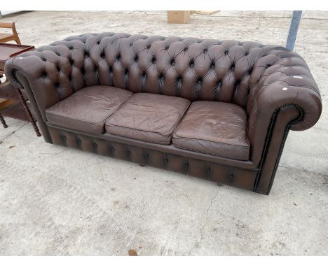 A BROWN LEATHER LOW BUTTON BACK CHESTERFIELD THREE SEATER SOFA 