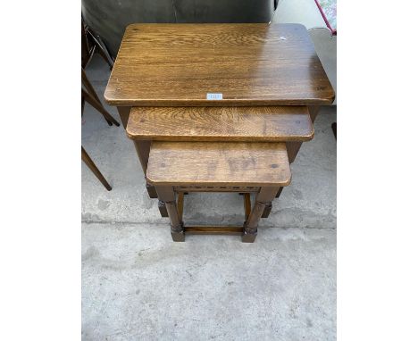 A BELIEVED ERCOL NEST OF THREE  OAK TABLES 