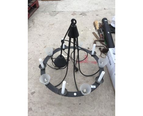 A LARGE BLACK MEDIEVAL STYLE CIRCULAR LIGHT FITTING WITH GLASS SHADES AND CANDLE HOLDERS 
