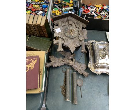 A WOODEN CARVED CUCKOO CLOCK 
