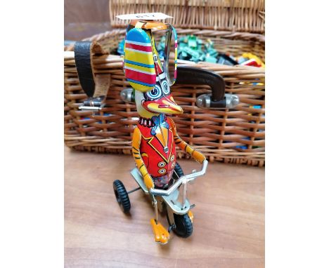 A VINTAGE TINPLATE WIND UP DUCK MODEL ON TRICYCLE 