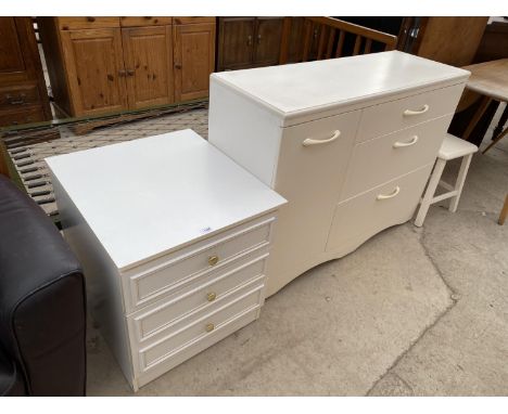 A WHITE BEDSIDECHEST OF THREE DRAWERS, A WHITE CABINET WITH ONE DOOR AND THREE DRAWERS AND A WHITE STOOL 