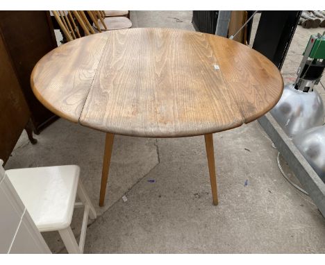 AN ERCOL OVAL ELM DROP LEAF DINING TABLE 