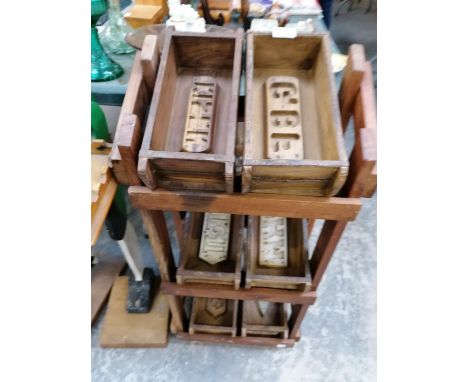 A WOODEN STAND WITH VINTAGE STYLE BRICK MOULDS 