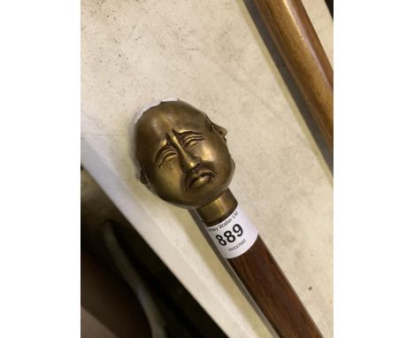 A FOUR FACED BUDDAH HANDLED WALKING STICK 