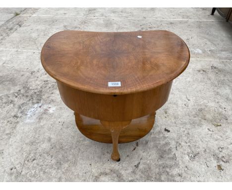 A WALNUT KIDNEY SHAPED SEWING TABLE WITH SILK LINING AND LOWER SHELF 