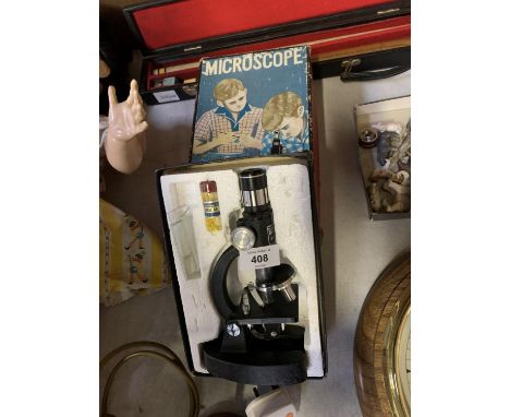 A VINTAGE BOXED STUDENTS MICROSCOPE 