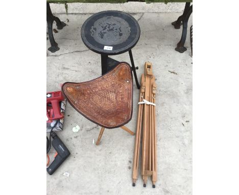 A LEATHER TOPPED THREE LEGGED FOLDING STOOL, AN EASEL AND A WOODEN CHINESE STYLE TABLE WITH LOWER SHELF 