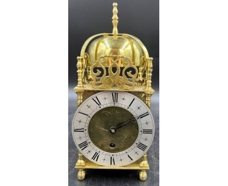 An 8 day brass lantern style mantle clock. The single train movement by Empire has platform escapement. 25cm h.Condition Repo
