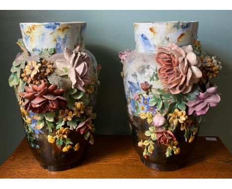 A pair of 19thC continental ceramic vases 46cm h. Liberally decorated with flowers.Condition ReportSome chips to petals.