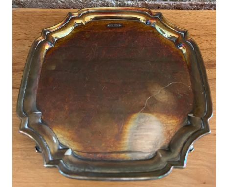 A silver card tray raised on scroll feet, Sheffield 1978, maker Parkin Silversmiths Ltd. 19 x 19cm.