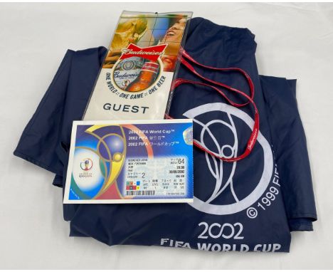 A 2002 FIFA World Cup used ticket in Budweiser Lanyard together with a 2002 FIFA World Cup hooded cape.Condition ReportGood u