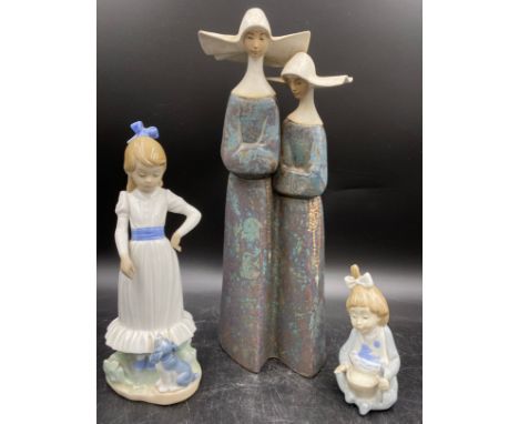 Lladro, a figurine of a pair of stoneware Nuns, height 34cm together with two Lladro Nao figures.Condition ReportNao figure o