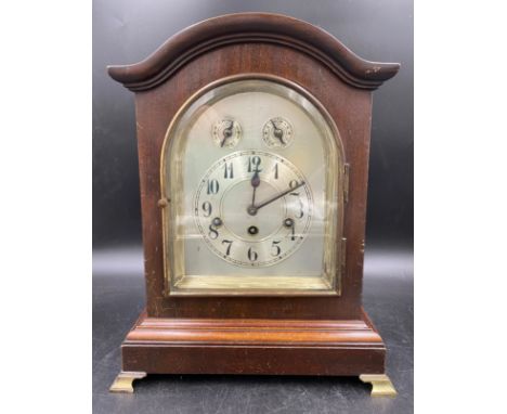 A mahogany cased mantle clock with German movement by Junghans Wurttemberg and Westminster charm. Pendulum and key present. 3