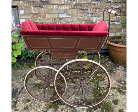 A 19thC wood and iron pram with ceramic handle with recently upholstered interior. 93 l x 48cm w. Condition ReportSome slight