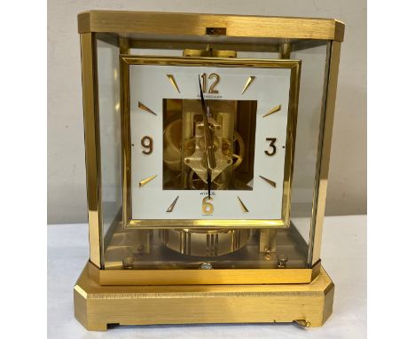 A Jaeger-Le-Coultre gilt brass Atmos mantle clock, movement numbered 390889, white enamel face. 23.5 h x 22 w x 14.5cm.Condit