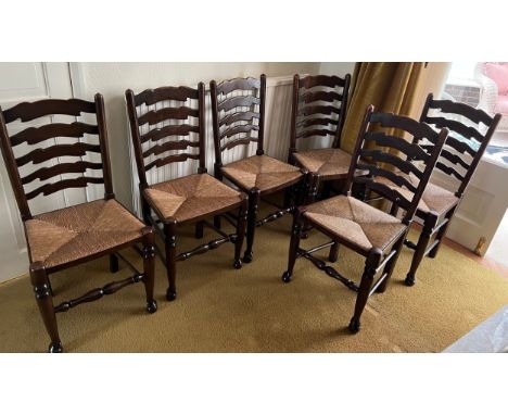 Six oak ladder backed chairs with rush seats.Condition ReportGood condition.