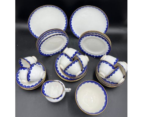 Royal Worcester part tea service comprising 2 x large plates, 11 x tea plates, 12 x saucers, 11 x cups and milk and sugar bow