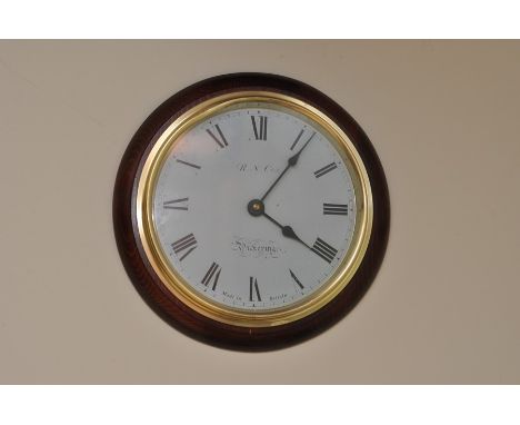 Railway style circular wall clock, dial marked  R N Cox Pickering with Roman Numerals D20cm, quartz movement 