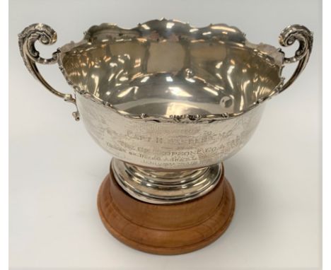 A George V silver twin-handled pedestal trophy bowl with foliate cast rim and flying scroll handles, maker Adie Brothers Ltd,