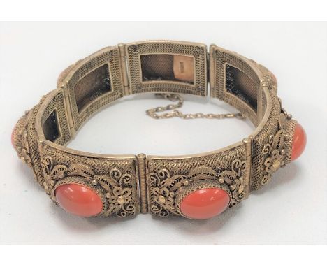 A Chinese silver gilt filigree seven section bracelet, each section set with oval cornelian cabochons, stamped SILVER, weight