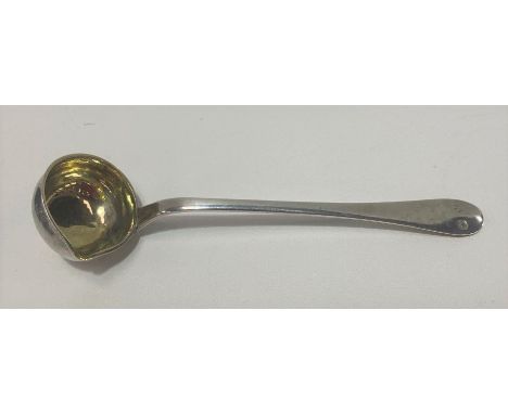 A continental white metal sauce ladle, of plain form and with interior gilded bowl, two punched marks to the handle, length 4