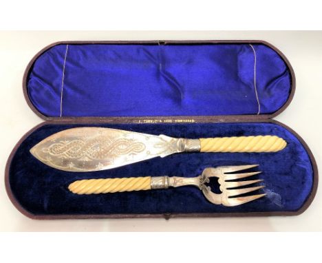 A Victorian silver plated wrythen fluted carved ivory handled fish serving knife and fork within original burgundy Moroccan g