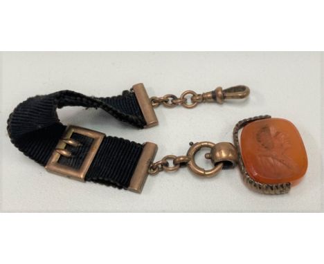 19th Century 9ct rose gold swivel cornelian fob intaglio with a portrait of a gentleman upon a ribbon with gold mounts and cl